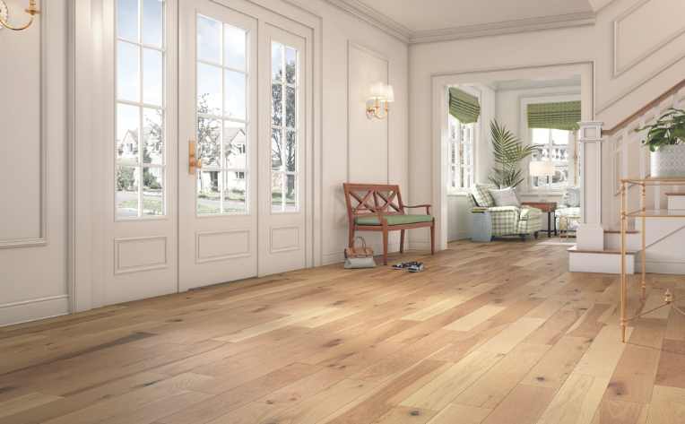 light hardwood flooring in entryway of white house with green accents